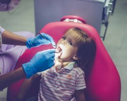pediatric dentist. Little girl at the reception at the dentist.